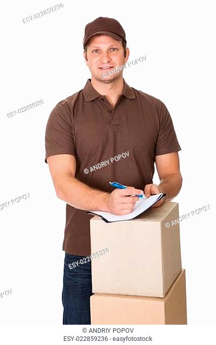 Portrait of delivery man doing paperwork