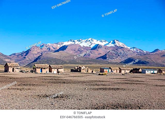 Small village of shepherds of llamas in the Andean mountains. High Andean tundra landscape in the mountains of the Andes