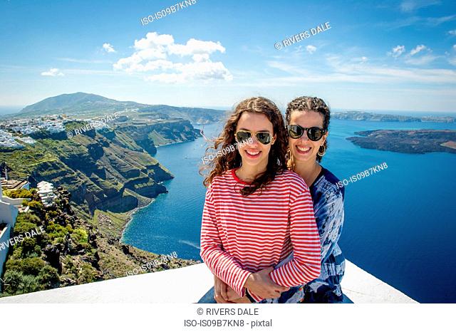 Mother and daughter hugging, sea in background, Oía, Santorini, Kikladhes, Greece