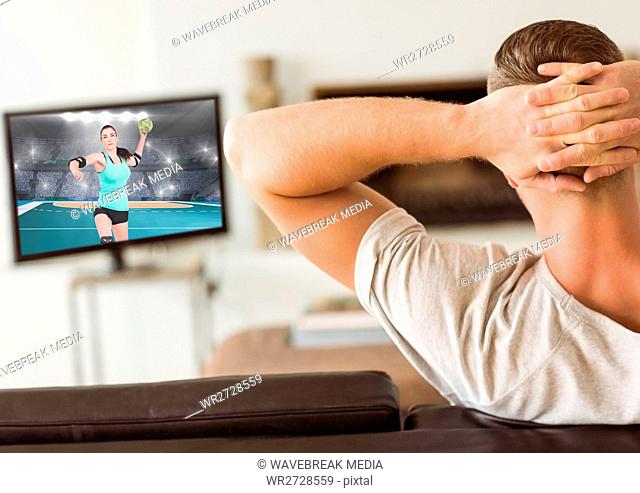 Man watching handball on television at home
