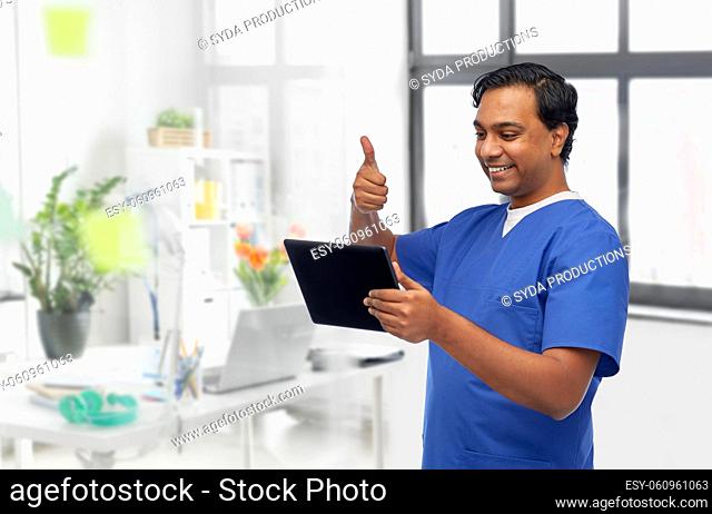 doctor or male nurse has video call on tablet pc
