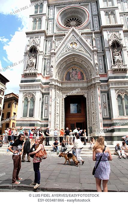 Tourists in front of the facade of Santa Maria del Fiore cathedral, Piazza del Duomo, Florence, Italy