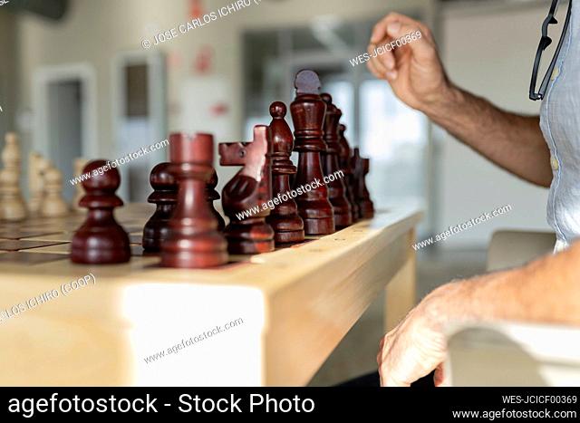 Businessman playing chess in office