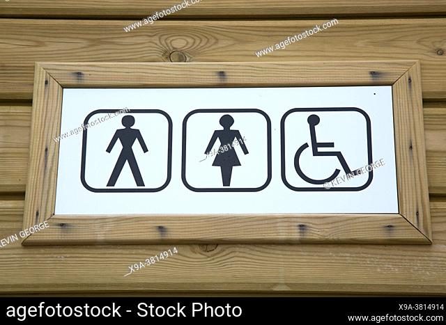 Ladies and Gents Toilet WC Sign on Wooden Background