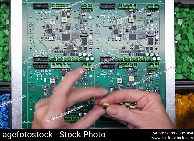 17 November 2023, Saxony, Schöneck: An employee assembles a circuit board for digital radios in the production facilities of TechniSat Vogtland GmbH