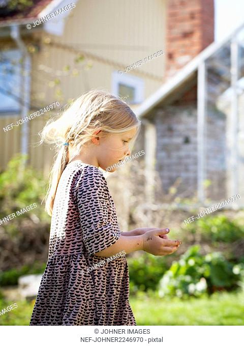 Girl wearing dress, walking in garden