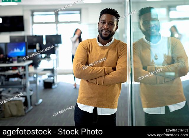 Portrait of businessman smiling at modern office