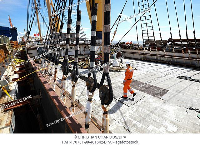 Workers prepare the departure of the museum ship 'Peking' (lit. Beijing) at the transport ship 'Combi Dock III' in Brunsbuettel,  Germany, 31 July 2017