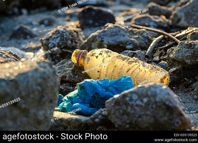Plastic bottle at rock. Plastic contamination. Environmental pollution