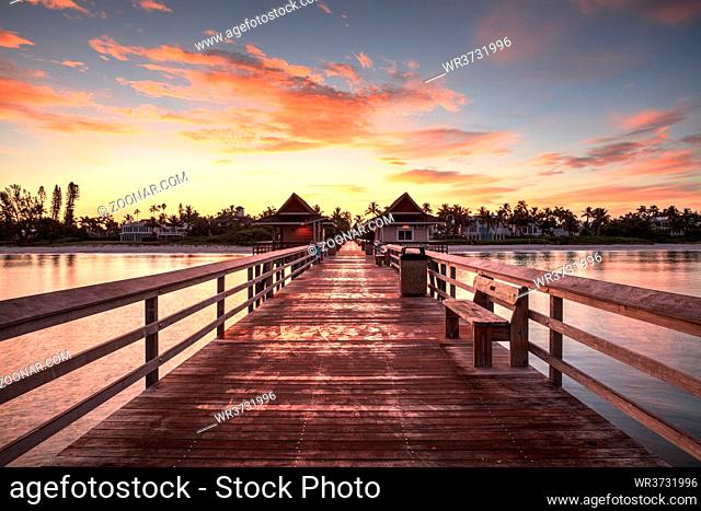 Early sunrise over the Naples Pier on the Gulf Coast of Naples, Florida in summer