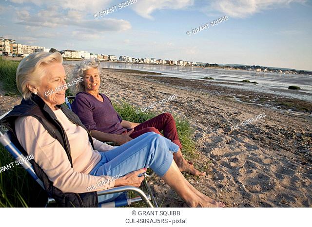 Mother and daughter enjoying view on beach
