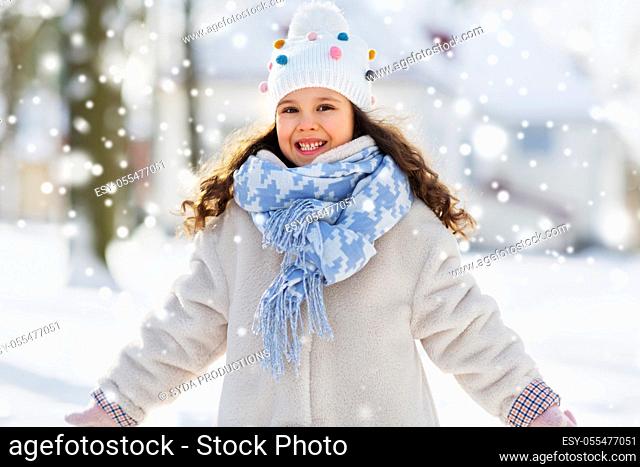 happy little girl in winter clothes outdoors