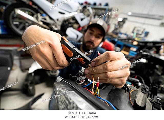 Mechanic in a repair garage repairing a motorcycle