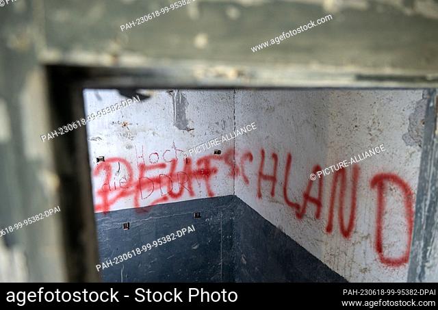 PRODUCTION - 14 June 2023, Saxony, Heinersgrün: ""Hail to the GDR!"" and ""Germany"" are written on a wall in a room in the last GDR border tower on Saxon soil...