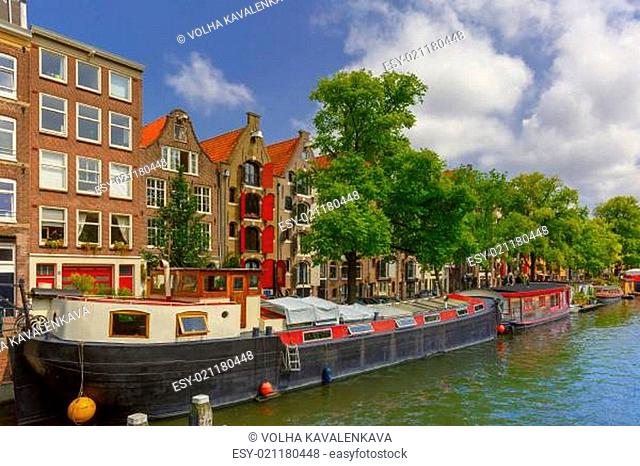 City view of Amsterdam canal with picturesque houseboats and typical houses, Holland, Netherlands