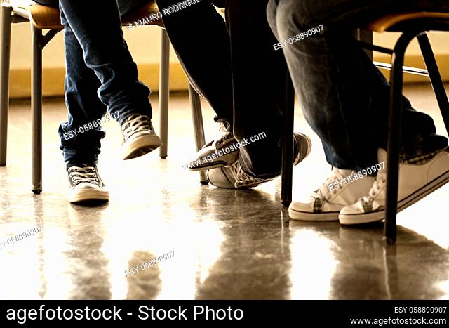 View of some teenager legs on a classroom