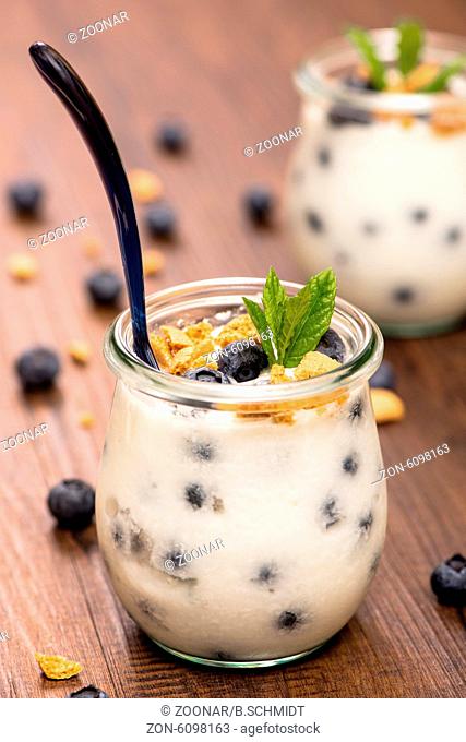 Glass with yogurt, blueberries and mint
