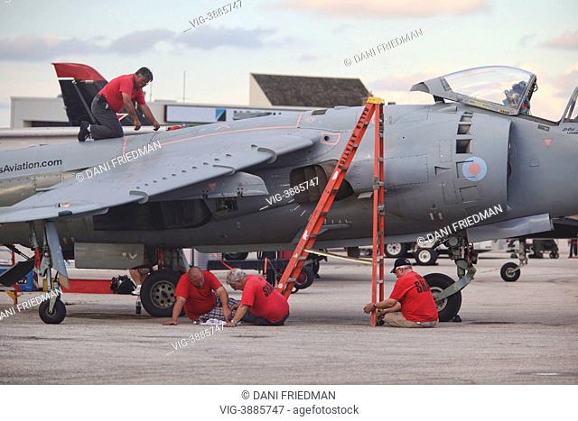 CANADA, MISSISSAUGA, Workers repair a British Aerospace Sea Harrier FA2 airplane outside a hangar after the Toronto International Air Show in Mississauga