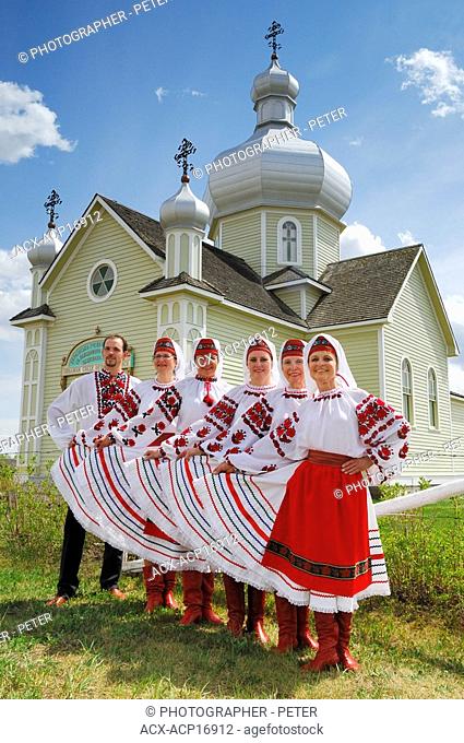 Ukrainian dancers pose in front of St.Vladimir's Ukrainian Greek Orthodox Church in the Ukrainian Cultural Heritage Village, east of Edmonton, Alberta, Canada
