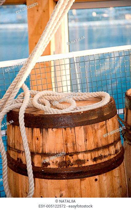 Barrel and rope on sea background