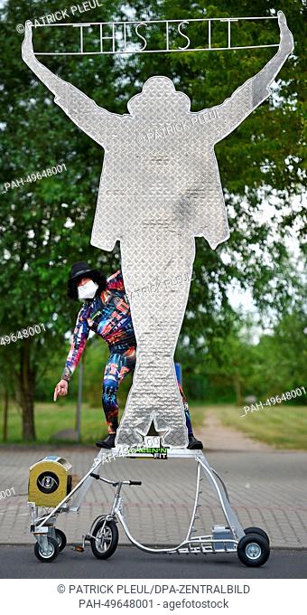 Bicycle designer Dieter 'Didi' Senft is dressed up as King of Pop Michael Jackson as he presents his newest creation in Storkow, Germany, 24 June 2014