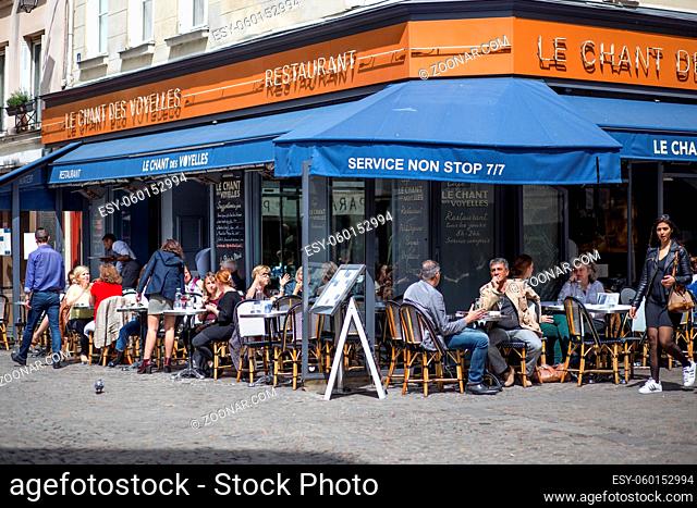 Paris, France - May 11, 2017: People sitting in the outside area of a restaurant in the street of Paris