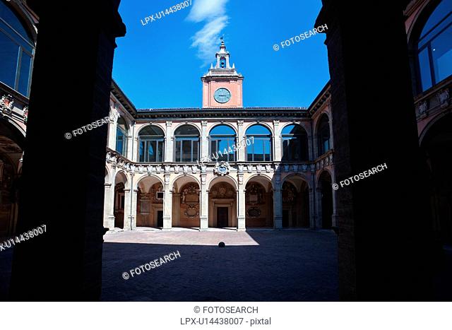 Loggia at entrance of Palazzo Archiginnasio, with view from under arch, of the two-tiered Renaissance buildings and central tower surrounding the courtyard