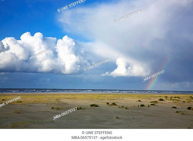 Shower and rainbow over the North Sea and the wide sand plain in the east of the island Langeoog
