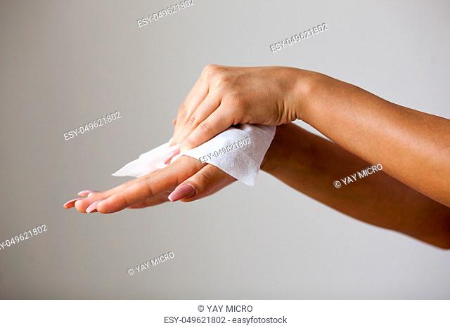 Young woman clean hands with wet wipes