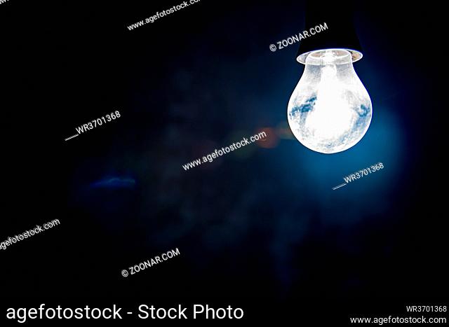 Electric lighting bulb on the dark background