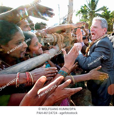 German President Joachim Gauck visits the village Muddapur and shakes hands with the villagers near Bangalore, India, 08 February 2014