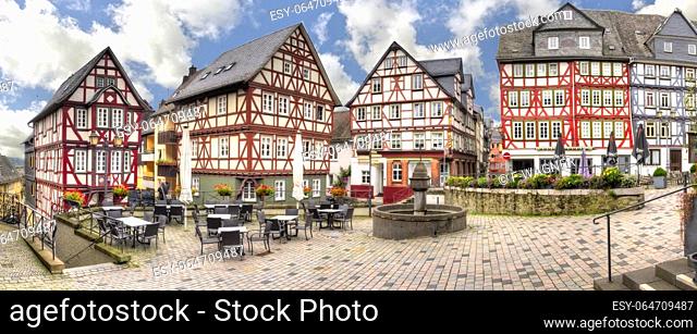 Ensemble of half-timbered houses, at the Kornmarkt in the historic old town of Wetzlar, Hesse with a deserted street cafe
