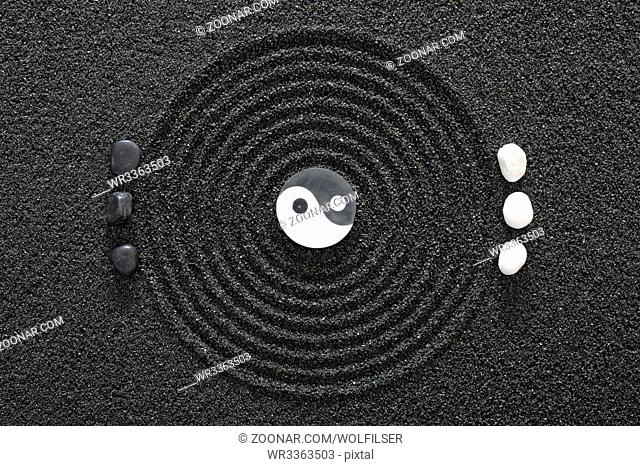 Japanes zen garden with yin and yang stones in raked sand