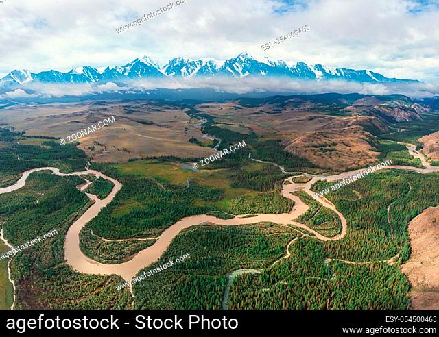 Kurai steppe and Chuya river on North-Chui ridge background. Altai mountains, Russia. Aerial drone panoramic picture. Giant ripples of the flow of water 15...