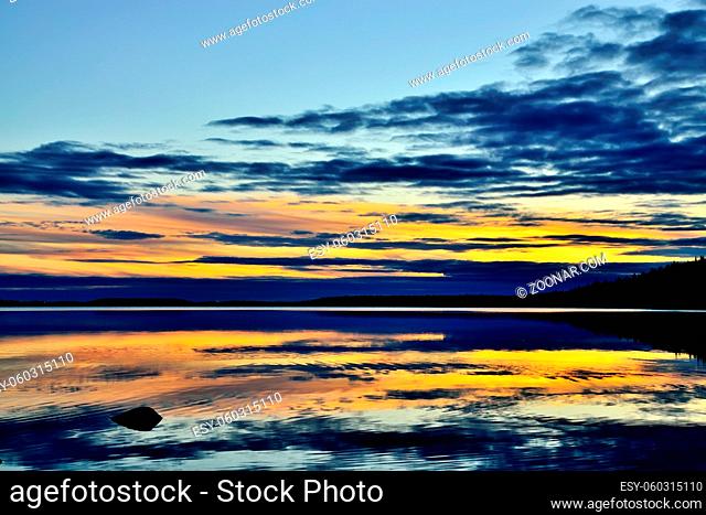 Mirror sunset on lake Keret, Northern Karelia, Russia