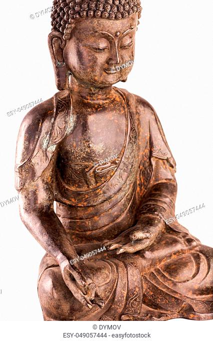 Buddha Shakyamuni's figure in a blessing pose - varada mudra. The old statue made of metal isolated on a white background