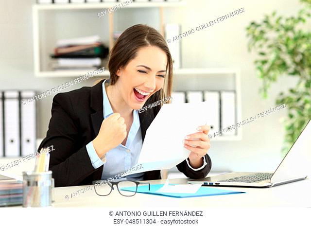 Excited office worker reading good news in a letter