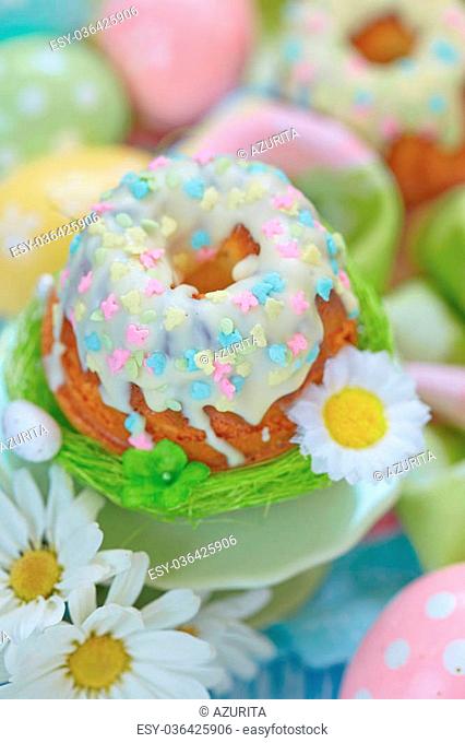 Easter cupcake on a stand with eggs and flowers