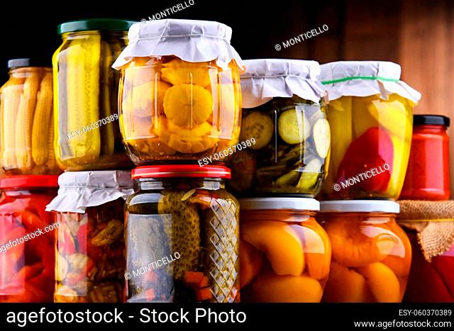 Jars with variety of marinated vegetables and fruits. Preserved food