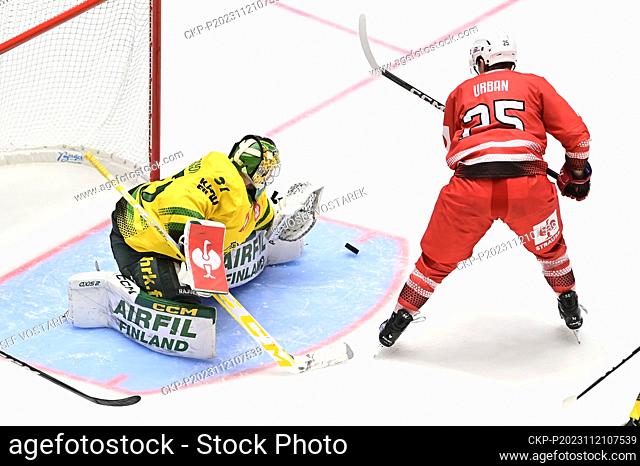 Jonas Gunnarsson, goalkeeper of Tampere, left, and Tomas Urban of Pardubice in action during the Ice Hockey Champions League playoffs