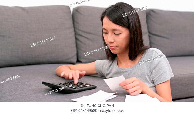 Woman calculate the spending of daily life at home