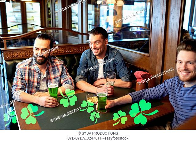 male friends drinking green beer at bar or pub