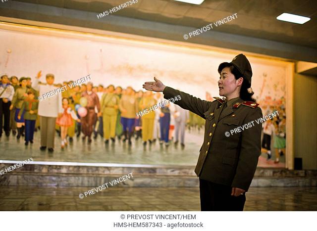 North Korea, Pyongyang, Victorious Fatherland Liberation war Museum, female soldier guide describing a frescoe showing Kim Il-Sung