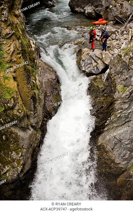 Two kayakers scope a line on Sand Creek, Galloway, British Columbia, Canada