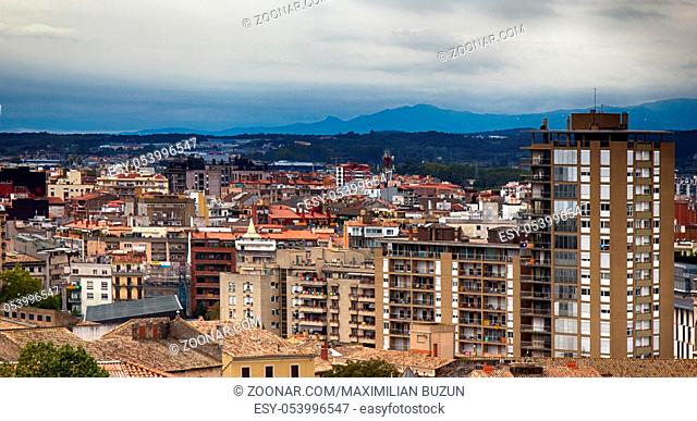 Romantic white city on hills - Spanish town Girona in foothills of Pyrenees - between peaks of Pyrenees mountains and Mediterranean sea. New city