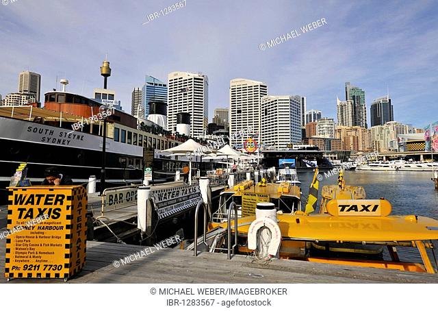 Water taxis in Darling Harbour in front of Sydney Tower or Centrepoint Tower and the skyline of the Central Business District, Sydney, New South Wales