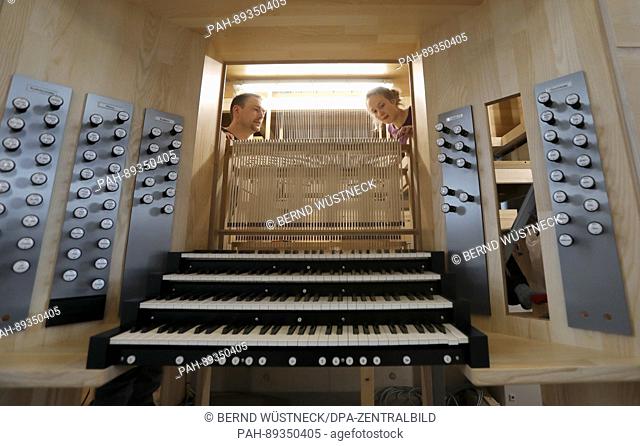 Construction manager Ansgar Gaulke and apprentice Helena Heckenbach of the Berlin Organ Construction company ""Karl Schuke"" works on the key tracts of a new...