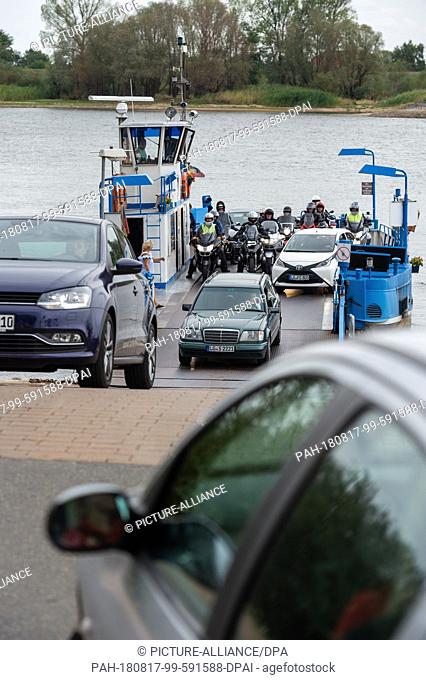 17 August 2018, Germany, Bleckede: The Elbe ferry ""Amt Neuhaus"" transports people and vehicles across the Elbe. The summer drought could bring the water level...