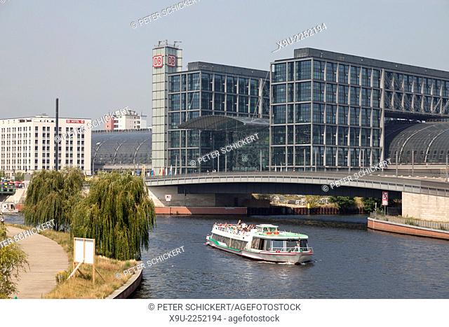 new main train station Hauptbahnhof and excursion boat on the river Spree in Berlin, Germany, Europe