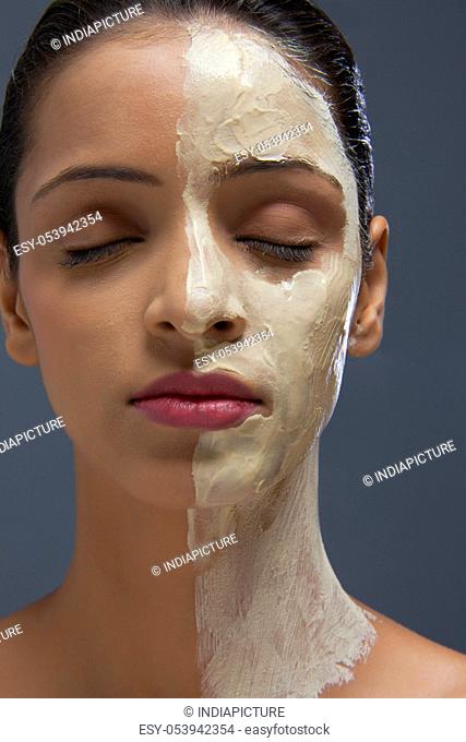 Close-up of young woman with facial mask